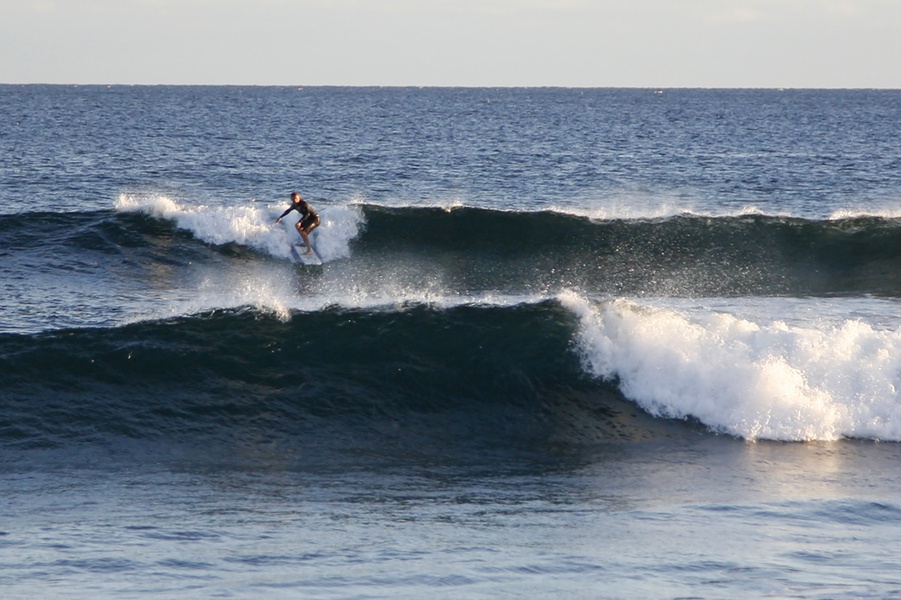 Surfing into the golden hour: a mesmerizing sunset surf session at Poipu Beach