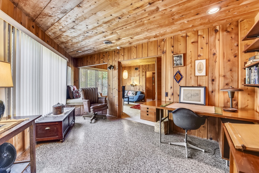 The warm natural light and strong cedar beams greet you as you enter the home through the eclectic living room
