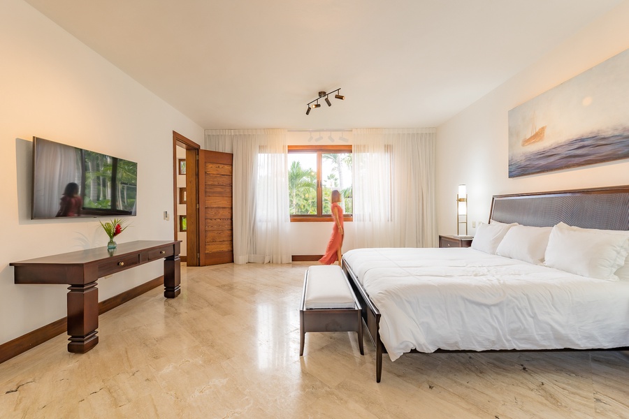 The guest bedroom also has ample natural light and modern decor.