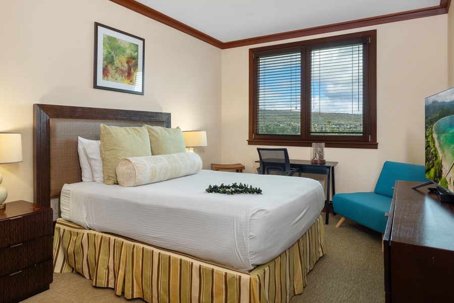 The guest bedroom with queen bed has natural light with views and plenty of storage.