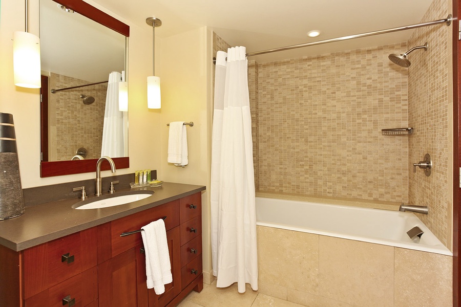 The third guest bathroom with a shower- tub combo.