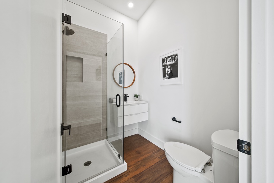 The ensuite bathroom features a separate walk-in shower and single vanity for convenience.