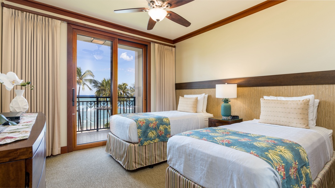 The second guest bedroom with twin beds and tropical views.