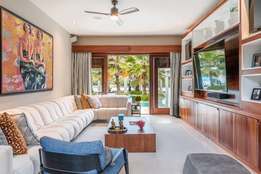 This living space features a cozy sofa, large TV and direct access to the outdoors.