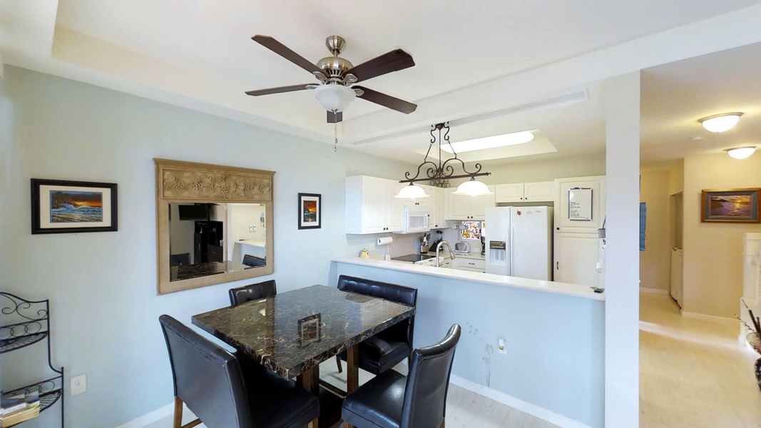 A classic bistro table that seats four with a bright open kitchen for hosting.