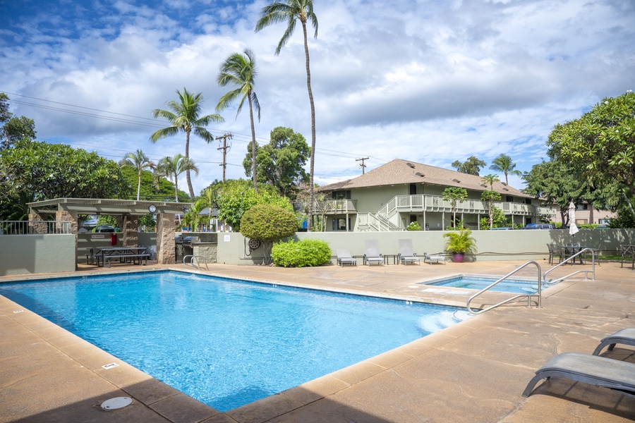 This beautiful tropical resort features a sparkling swimming pool surrounded by lush palm trees and comfortable poolside loungers for the perfect Hawaiian getaway.