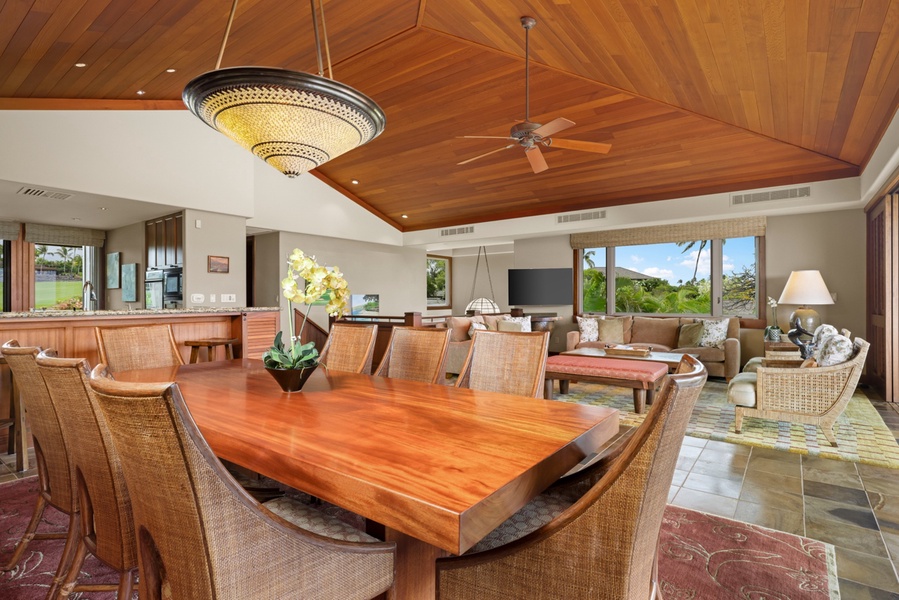 Interior dining table through open floor to ceiling pocket doors to exterior dining table.