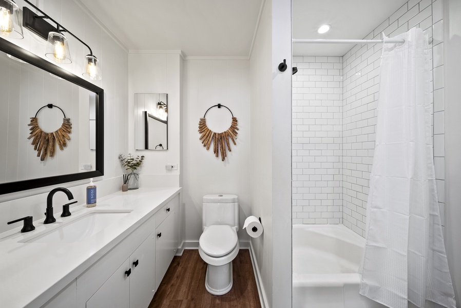 Bathroom featuring a walk-in shower, stylish vanity, and elegant tile accents, combining luxury with functionality.