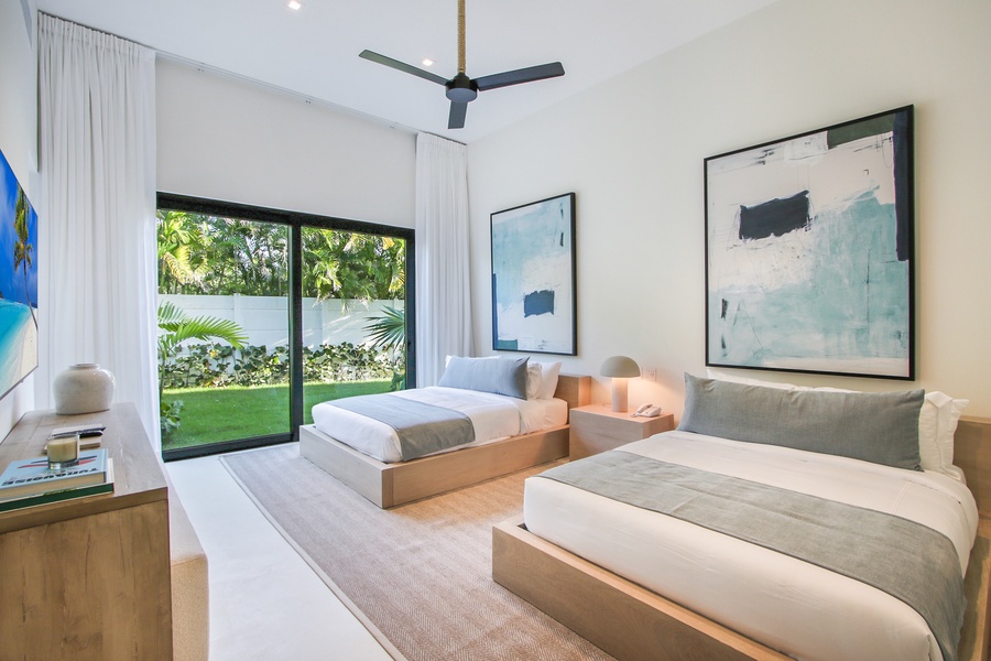 Unwind in a bedroom with modern decor and access to a lush garden.