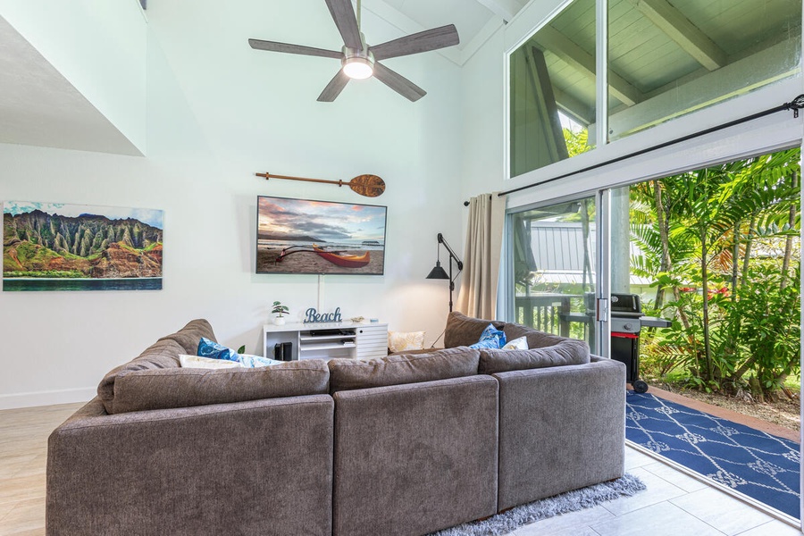 Breezy indoor-outdoor living with sliding doors that open to the tropical patio.