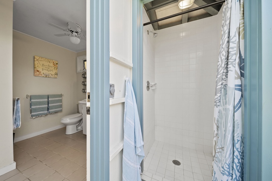 Refreshing outdoor shower, ideal for cooling off after a swim in the turquoise waters.