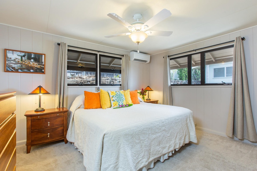 Primary bedroom with California king and split air conditioning for warm summer days.