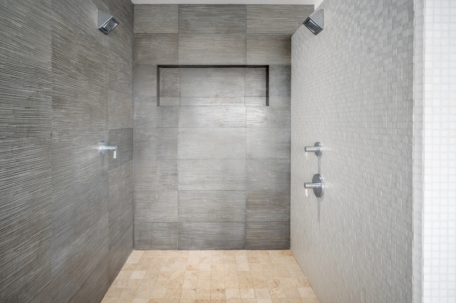 Unique shower with lava rock and tile finishes, blending natural elements with modern style.