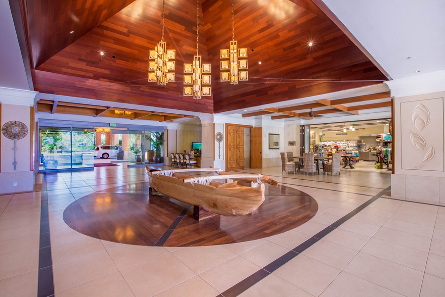 The grand lobby welcomes guests with its warm wood accents and elegant chandeliers, creating a luxurious yet inviting atmosphere