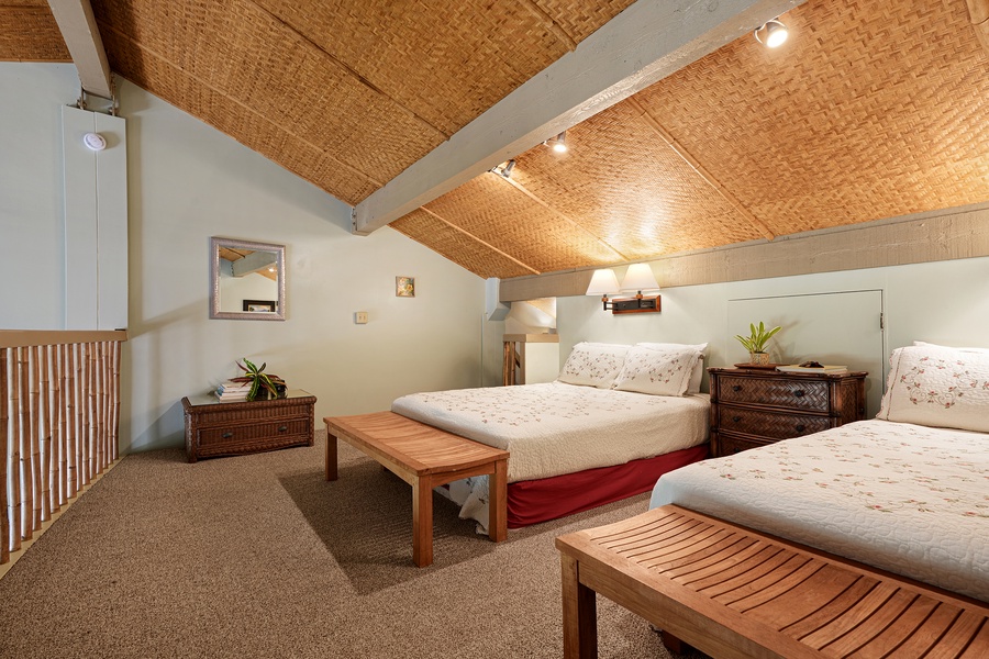 Relax in this spacious bedroom with cozy beds and a charming island-style design.