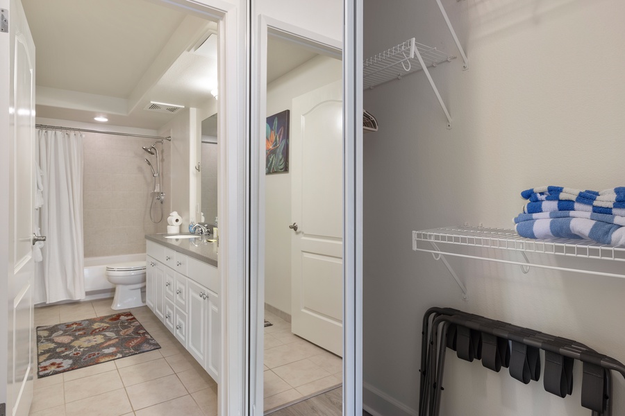 Your private bathroom offers a relaxing shower-tub combo with fresh towels and a spacious walk-in closet for all your belongings.