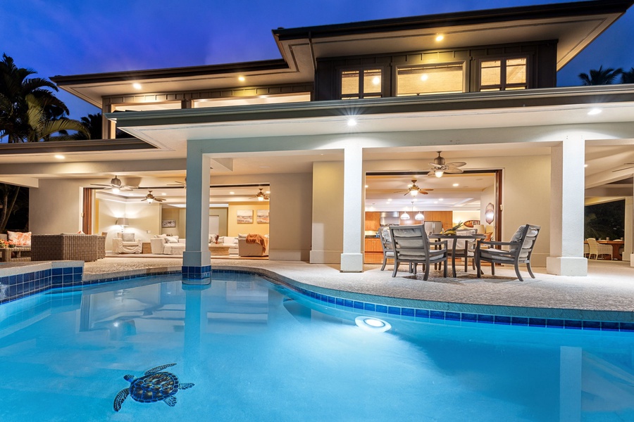 Illuminated pool and patio area, creating a serene evening ambiance.