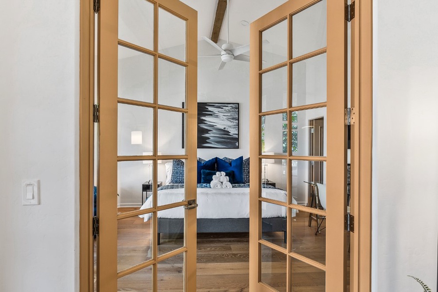 French doors provide a private entry to this king bedroom with blinds on all windows for privacy.  Perfect for someone who prefers a large bedroom on the same floor as the entry, kitchen, dining and living areas.