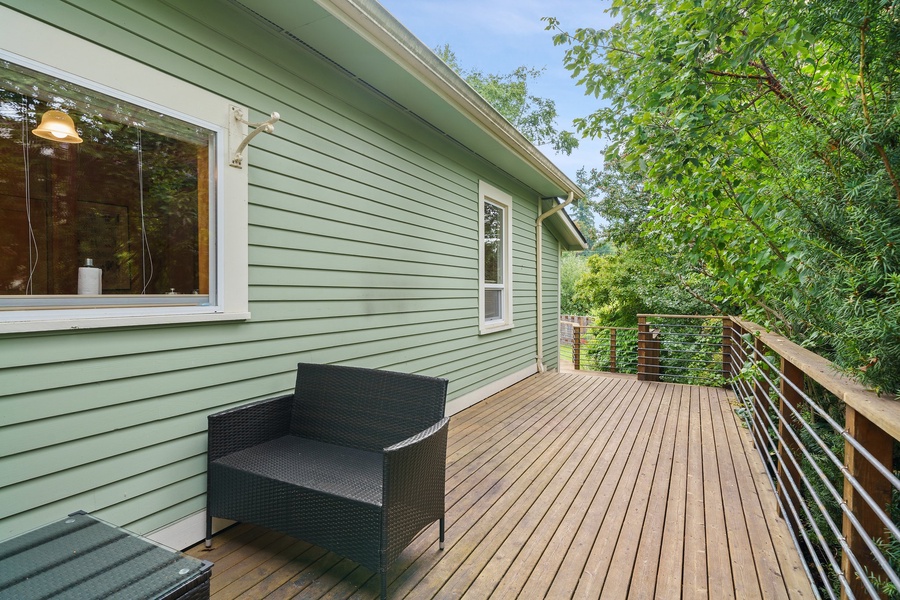 Step onto your private deck surrounded by lush greenery, where you can unwind in comfort.