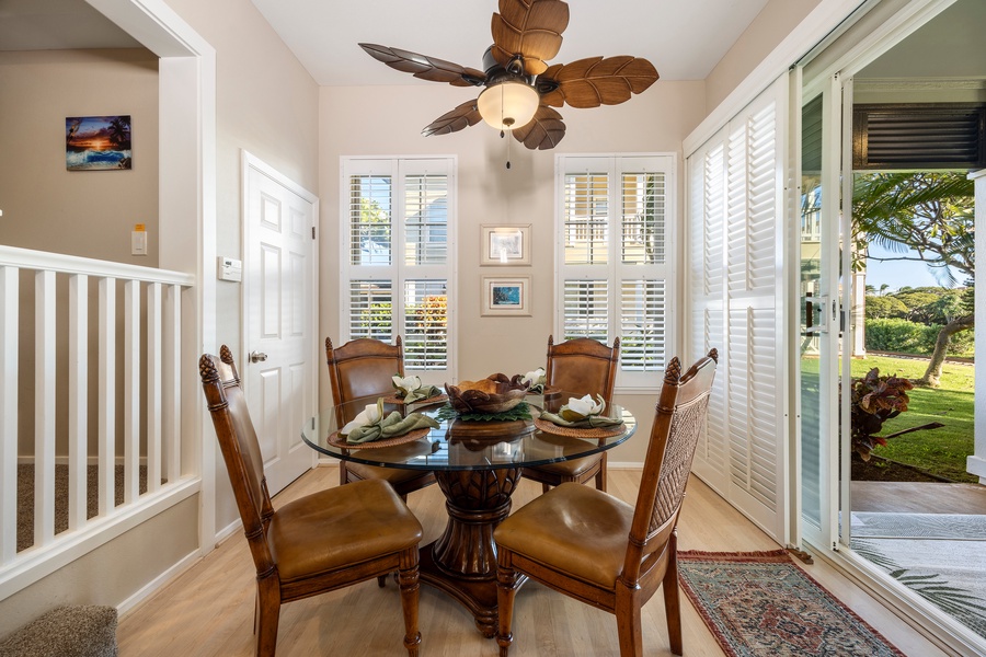 Gather around this elegant glass dining table where tropical breezes flow through open doors to your private garden oasis.