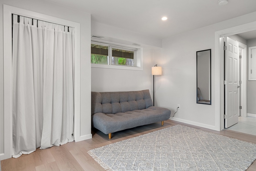 Cozy sitting area with a modern sofa and a floor lamp.