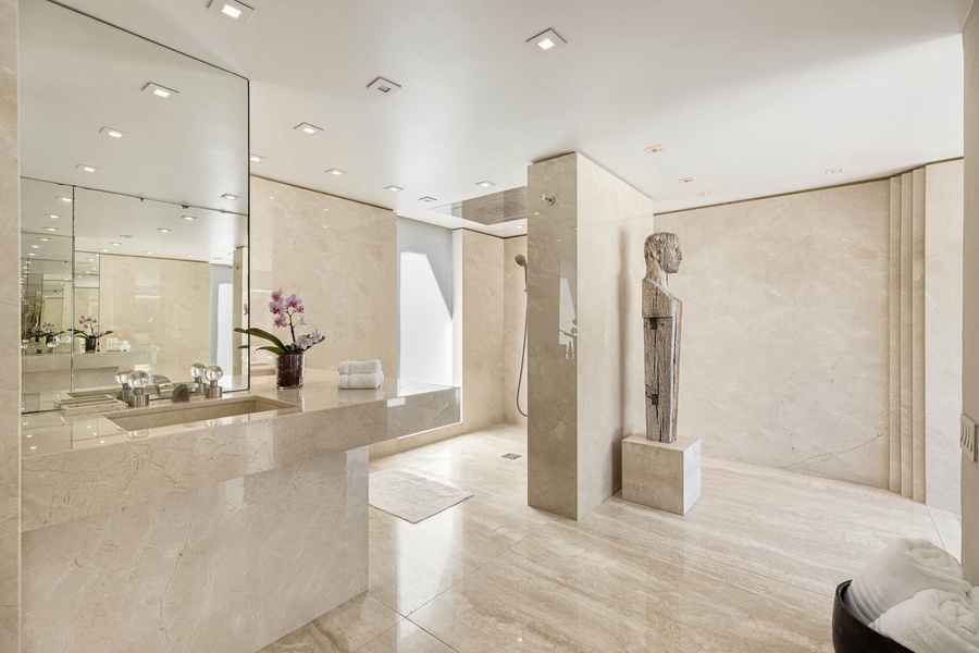 Ultimate spa-like experience in the primary ensuite with a spacious vanity and open walk-in shower.