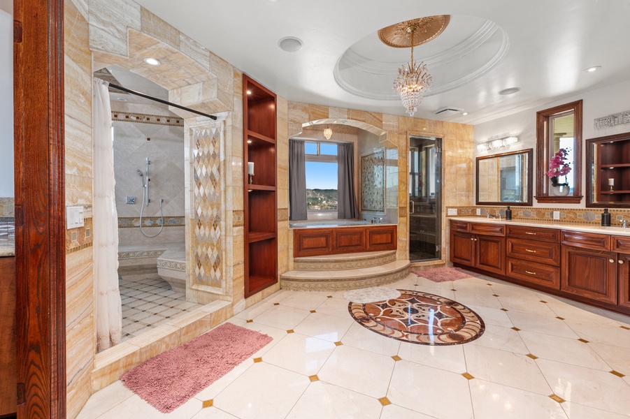 Set on a stone medallion, the soaking tub anchors its own room.