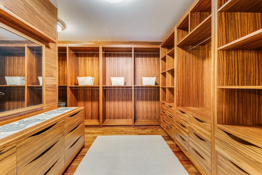 Custom-built walk-in closet with abundant storage and fine wood detailing.
