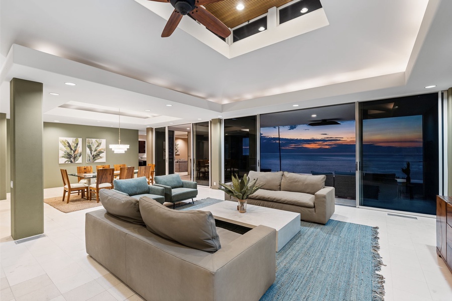 Unwind in your spacious living room where floor-to-ceiling windows frame breathtaking ocean views. Sink into plush seating as sunset colors paint the sky.