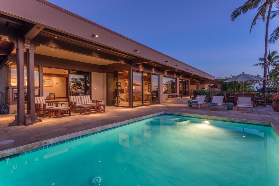 View of Pool at Twilight w/Primary Deck Seating, Great Room Sliding Doors & Lounge Seating. Pool is 4 feet deep.