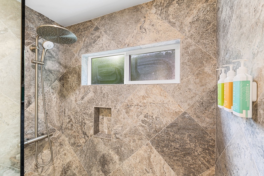 Step into a spacious walk-in shower, designed for a relaxing, spa-like reset.