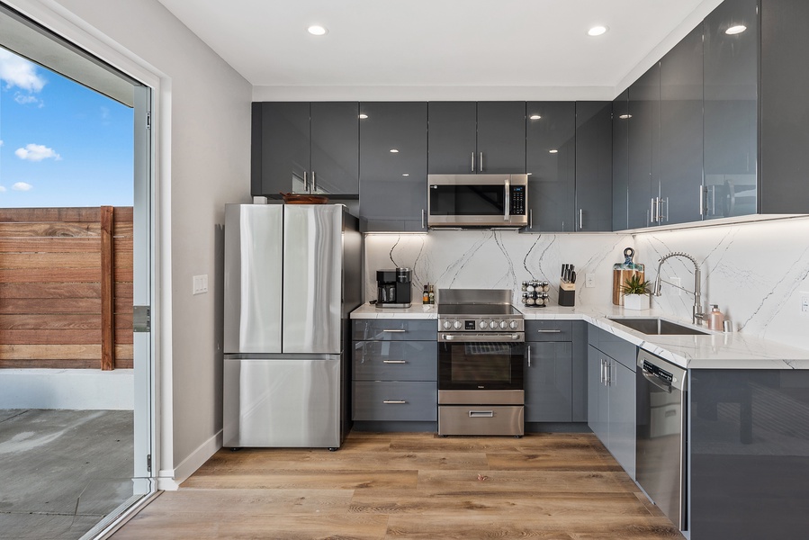 Stainless steel appliances in this fully functional kitchen.