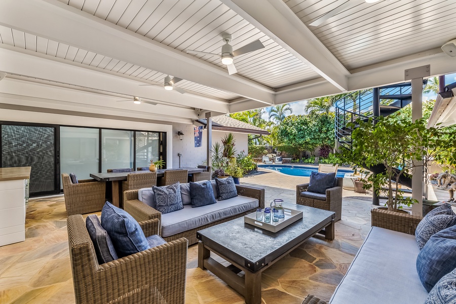 This covered lanai with ceiling fans interconnects with the indoor living area