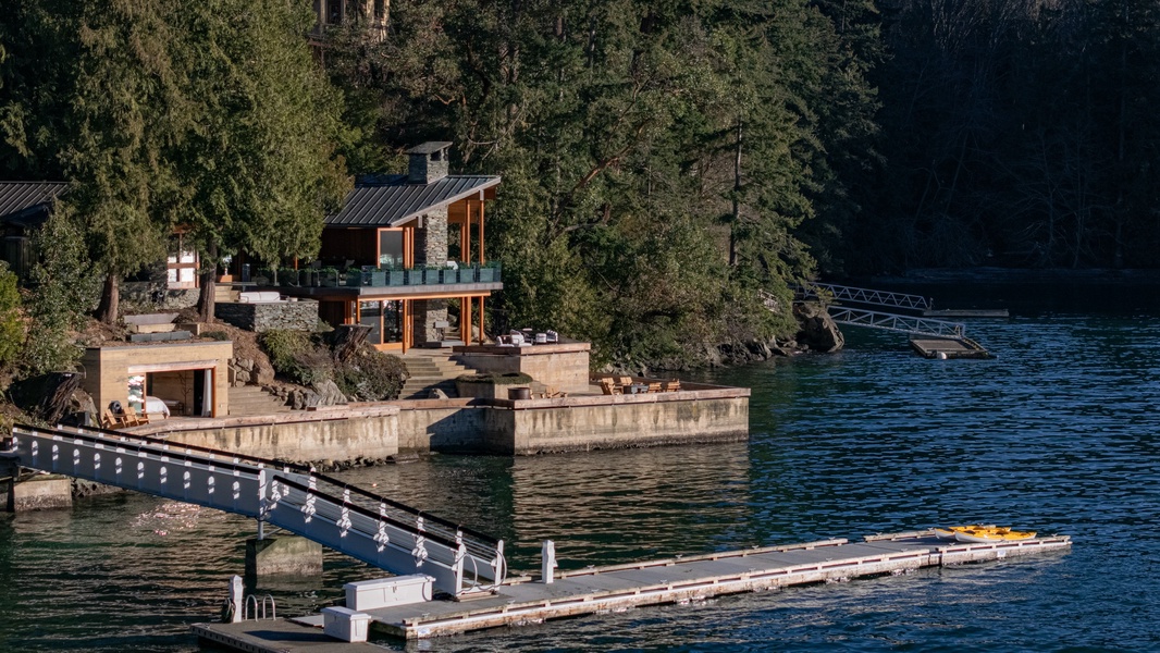 Stunning lakefront property nestled among mature trees with private dock and waterfront access for an unforgettable retreat.