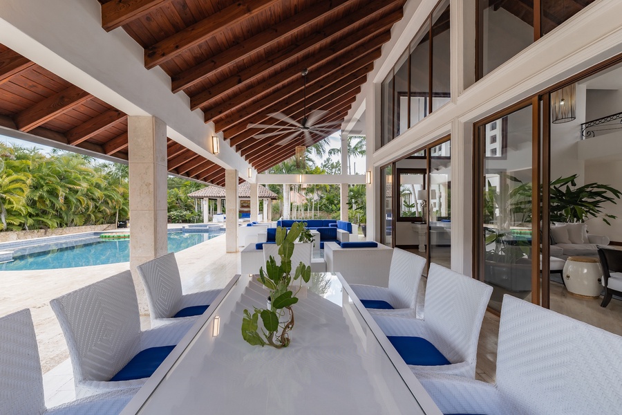 Covered outdoor dining area with pool views, perfect for enjoying the tropical surroundings.