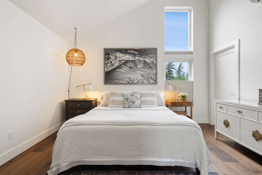 A cozy spot to rest with warm tones, high ceilings, and garden views.