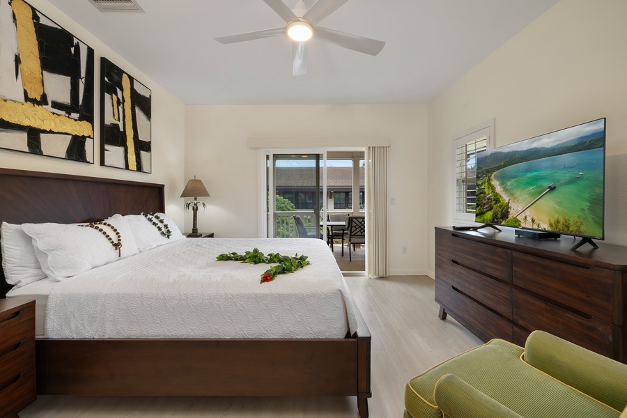 Spacious bedroom with a comfortable bed and a view of the outdoor patio.