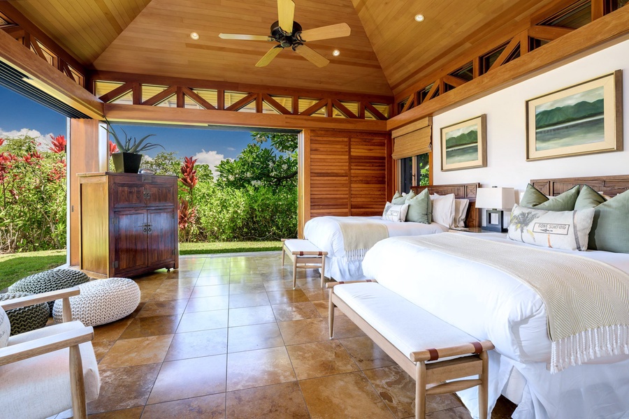 The second guest suite, with 2 full beds, allows complete outdoor immersion with doors that open fully to the yard and lanai.