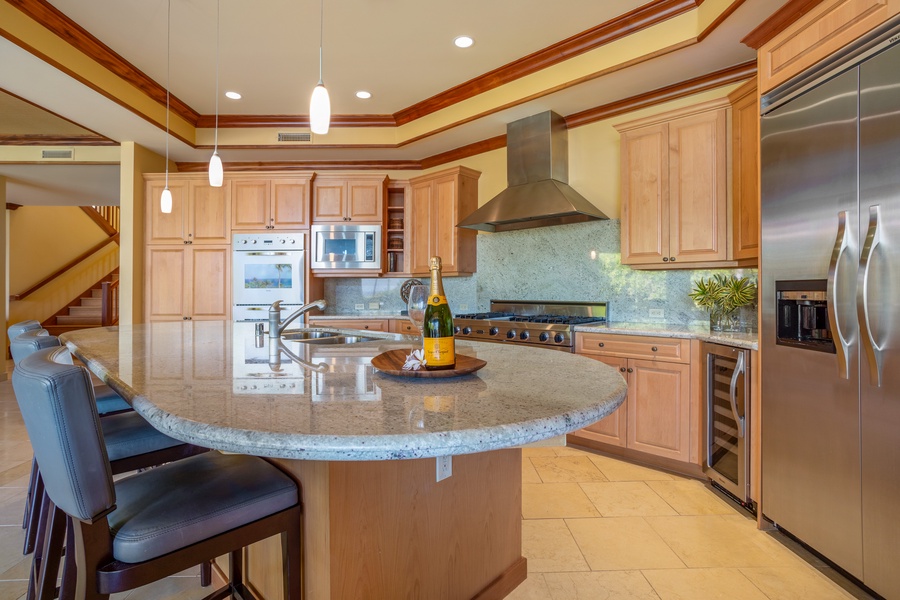 Large, open gourmet kitchen with breakfast bar seating