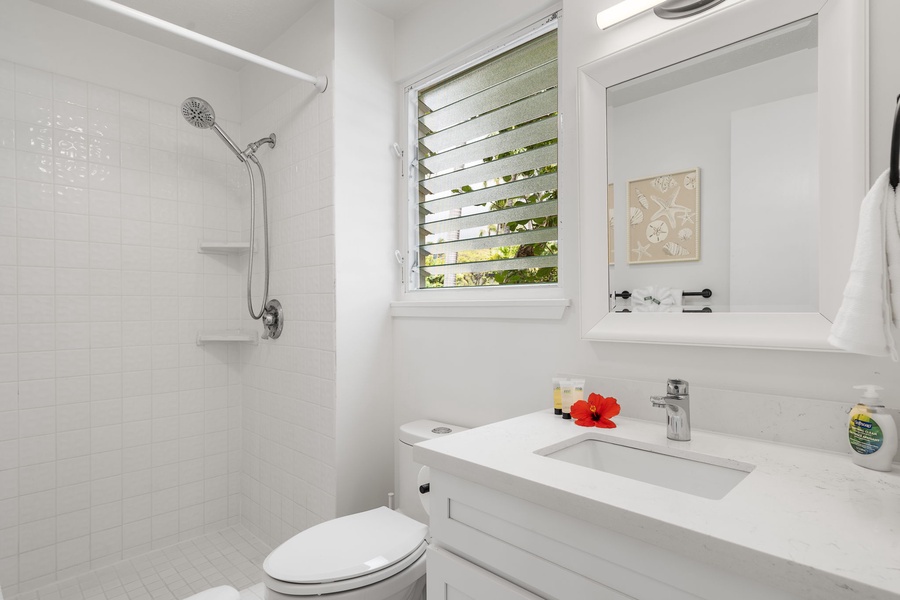 Clean and airy guest bathroom with ocean breeze and thoughtful tropical touches.