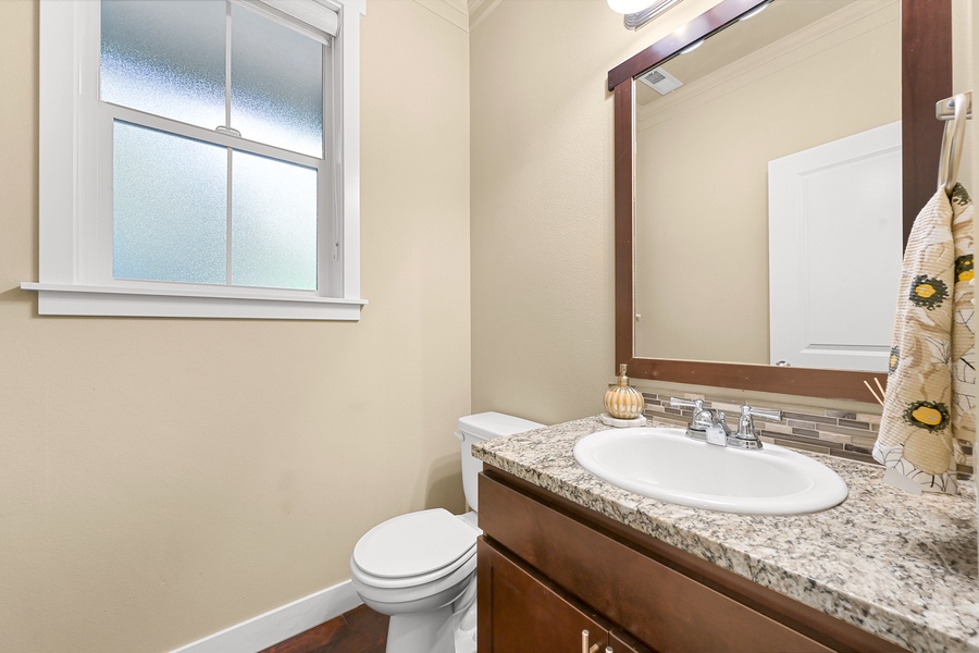 A convenient half bath on the main floor adds ease for guests and quick freshen-ups.