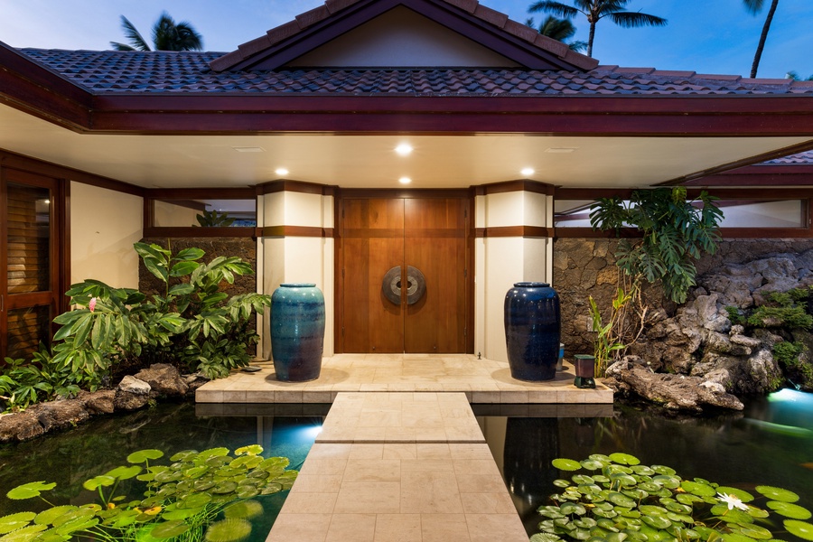 Arrive in style via the koi-lined entry bridge surrounded by lush island landscaping.