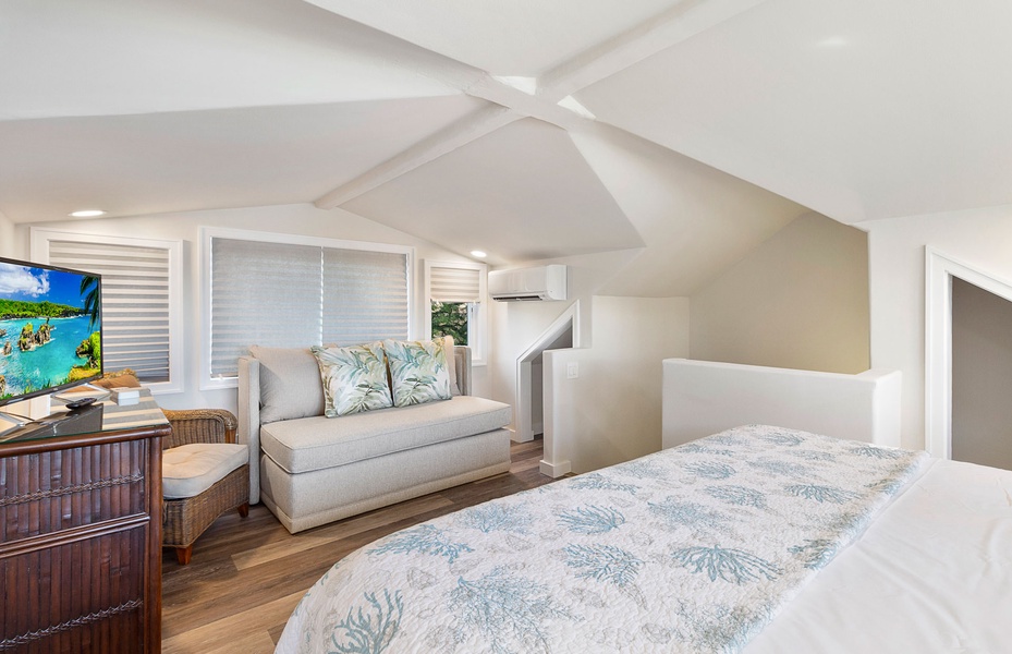 A beautifully designed guest bedroom with a cozy reading nook and serene ambiance.