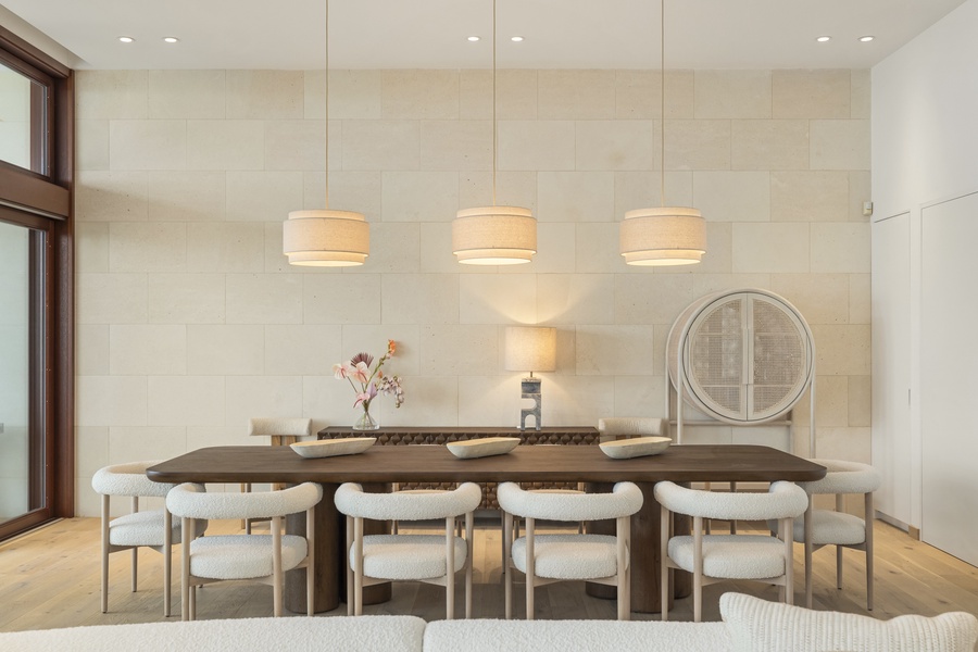 Elegant dining area featuring modern lighting and comfortable seating for ten for memorable gatherings.