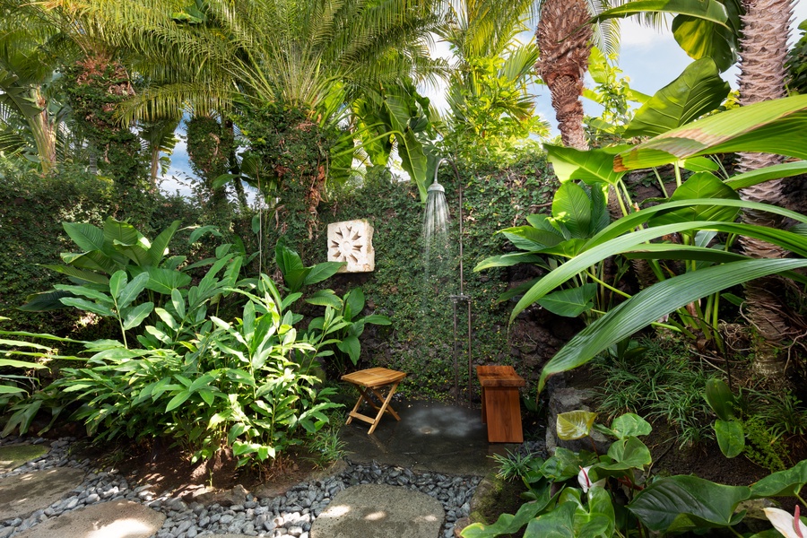 Lush garden outdoor shower for a refreshing rinse surrounded by nature.