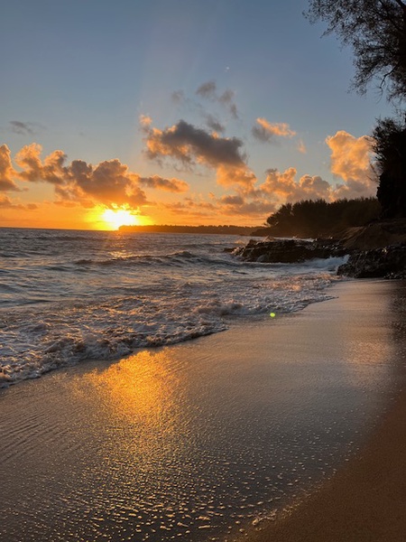 Golden sunset paints the sky as waves gently kiss this pristine beach, creating a breathtaking coastal paradise near the property.