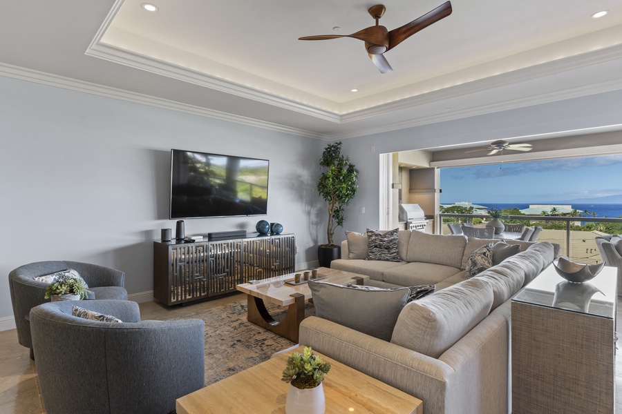 Unwind in the elegant living room, where modern design meets comfort, and enjoy easy access to the lanai with breathtaking ocean views.