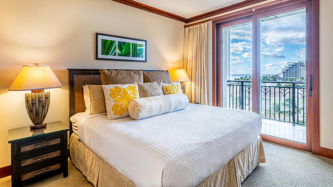 The primary guest bedroom features access to the lanai and designer touches.