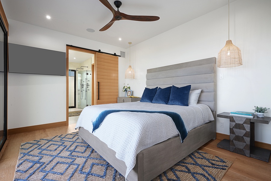 Cozy and inviting, this Ohana guest bedroom downstairs marries plush comfort with a dash of nautical charm, perfect for a peaceful night's sleep.