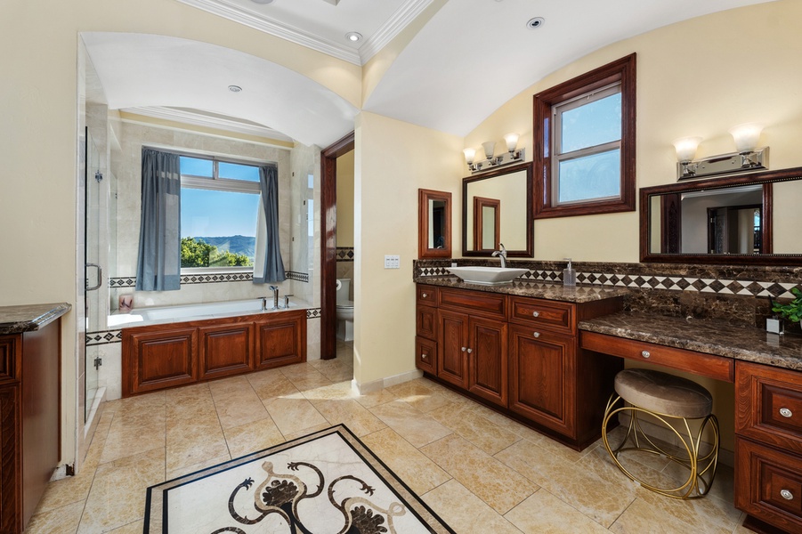 Stonework and a long vanity give this bath a sense of calm.